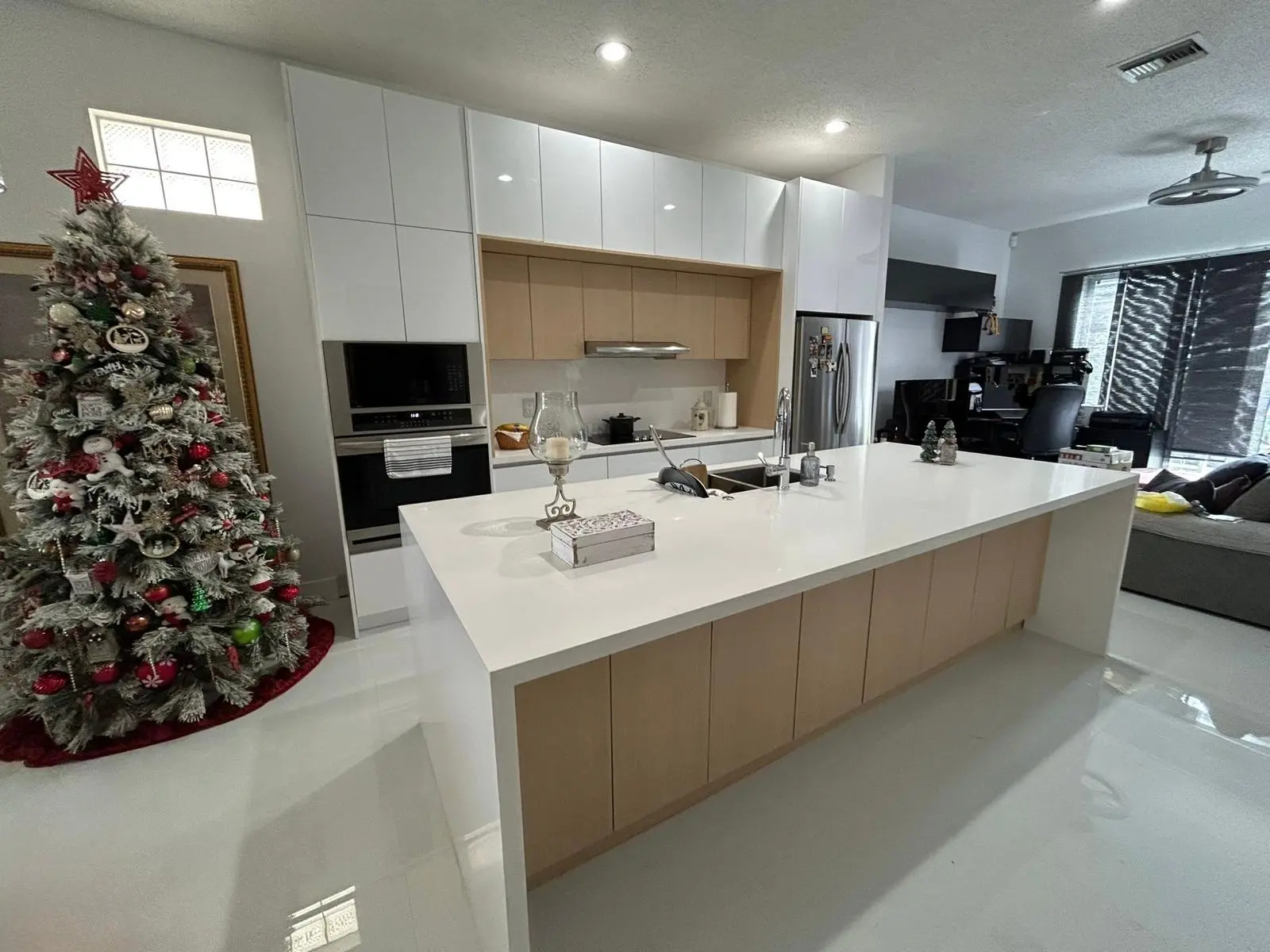 Glossy white kitchen with natural wood island