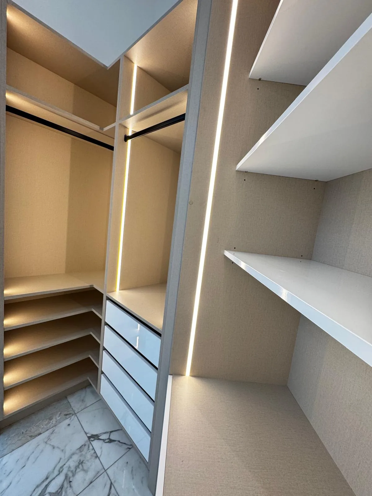 Boutique walk-in closet with marble floor